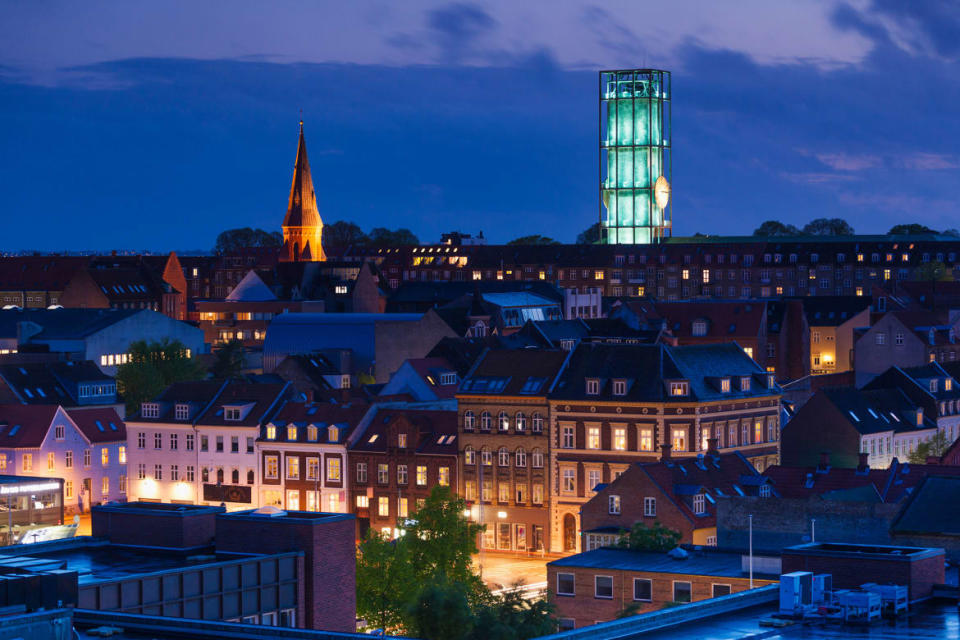 <div class="inline-image__caption"><p>Evening city view with Aarhus Town Hall, designed in 1942 by Danish architect Arne Jacobsen.</p></div> <div class="inline-image__credit">Walter Bibikow via Getty</div>