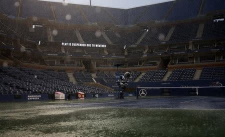 Arthur Ashe Stadium sits empty as rain falls on the court at the 2014 U.S. Open tennis tournament in New York, August 31, 2014. REUTERS/Ray Stubblebine