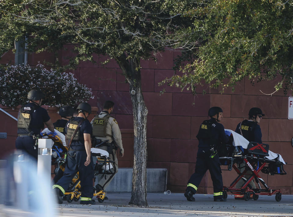 Gurneys are brought to the scene of a fatal shooting that killed several people on the University of Nevada, Las Vegas campus, on Wednesday, Dec. 6, 2023, in Las Vegas. The attack just before noon sent police swarming onto the campus, which is just a couple of miles from the world-famous Las Vegas Strip while students barricaded themselves in classrooms (Madeline Carter/Las Vegas Review-Journal via AP)