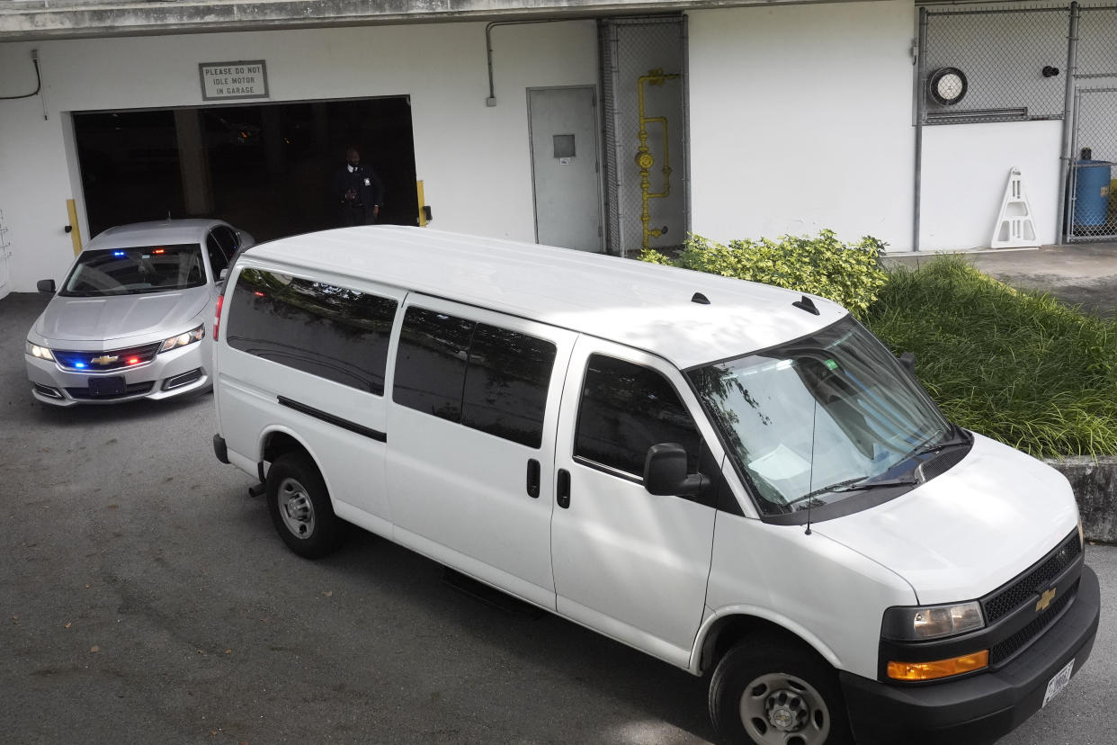 A prisoner transport van leaves the Paul G. Rogers Federal Building.