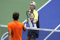 Denis Shapovalov, of Canada, right, taps rackets with Pablo Carreno Busta, of Spain, after his loss in the quarterfinals of the U.S. Open tennis championships, early Wednesday, Sept. 9, 2020, in New York. (AP Photo/Frank Franklin II)