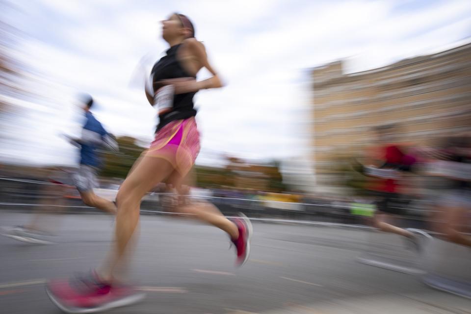 A runner turns the corner onto 18th Street during the Columbus Marathon.