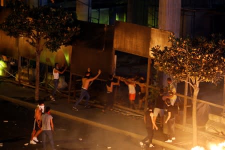 Demonstrators are seen during a protest over deteriorating economic situation in Beirut