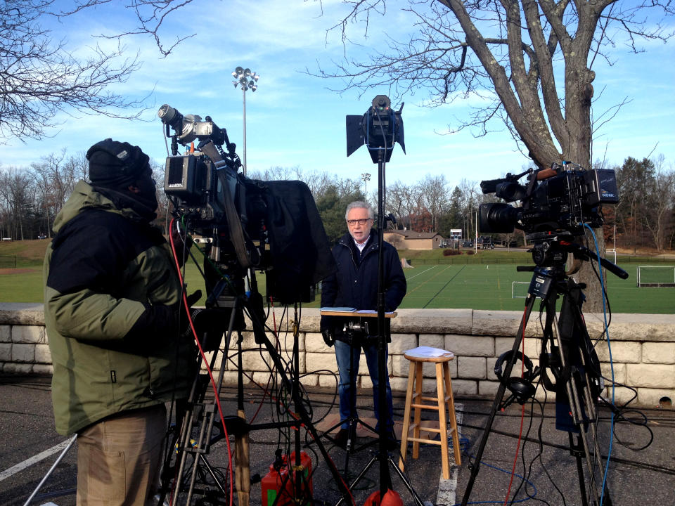 CNN's Wolf Blitzer standing near a sports field reports from Newtown, Conn.