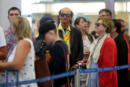 Thomas Cook passengers queue up in a check-in service at Malta International Airport