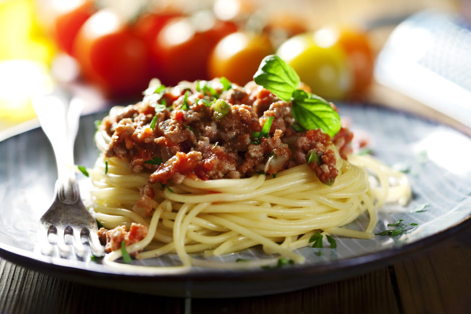 fresh pasta bolognese with basil, shallow dof, focus in front