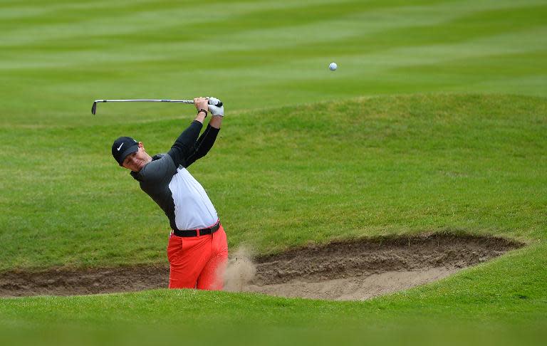 Northern Irish golfer Rory McIlroy plays his second shot after landing in his first bunker on the 3rd fairway on the second day of the PGA Championship at Wentworth Golf Club in Surrey, England, on May 22, 2015