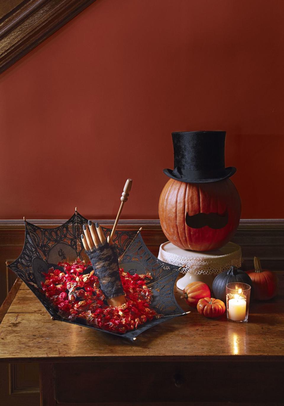 <p>A top hat and paper mustache make for one fancy jack-o'-lantern — no scooping, carving or painting required. Prop the squash on a <a href="https://www.amazon.com/TRSPCWR-Dessert-Display-Cupcake-Birthday/dp/B08P84KTRS/?tag=syn-yahoo-20&ascsubtag=%5Bartid%7C10055.g.1714%5Bsrc%7Cyahoo-us" rel="nofollow noopener" target="_blank" data-ylk="slk:cake stand;elm:context_link;itc:0;sec:content-canvas" class="link ">cake stand</a> for an extra-dignified perch.</p><p><a class="link " href="https://www.amazon.com/Black-Magician-Costume-Funny-Party/dp/B007ZFXDLG?tag=syn-yahoo-20&ascsubtag=%5Bartid%7C10055.g.1714%5Bsrc%7Cyahoo-us" rel="nofollow noopener" target="_blank" data-ylk="slk:SHOP TOP HATS;elm:context_link;itc:0;sec:content-canvas">SHOP TOP HATS</a><br></p>