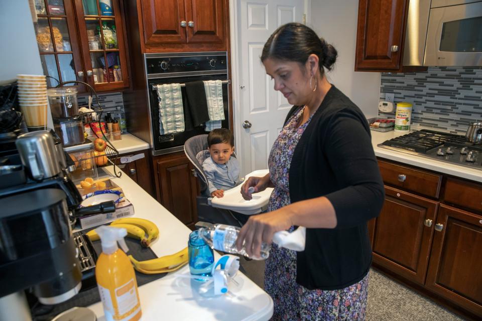 Joan Perez prepares to give 1 year 9 month old son Samuel Martinez some water after giving him a banana as a snack. Perez, who was born in Puerto Rico, was encouraged by her father to move to New Jersey to get a better education and job opportunities. She now lives in Bayonne with her husband and two children.