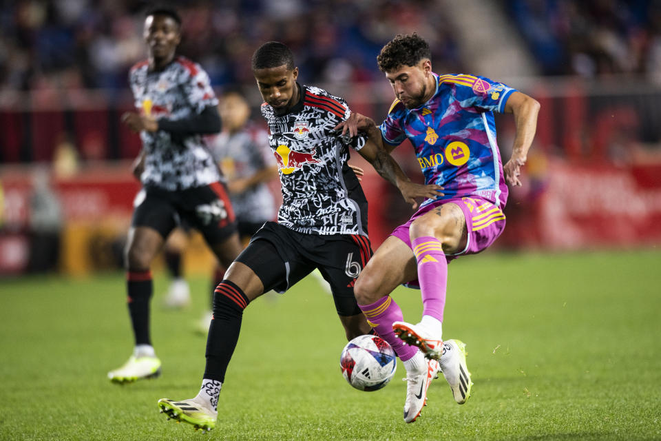 Toronto FC midfielder Jonathan Osorio, right, vies for the ball against New York Red Bulls defender Kyle Duncan during an MLS soccer match Saturday, Oct. 7, 2023, in Harrison, N.J. (AP Photo/Eduardo Munoz Alvarez)