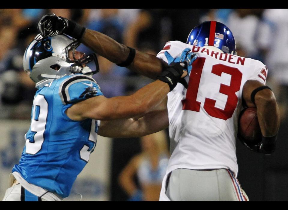 New York Giants wide receiver Ramses Barden (13) tries to break a tackle from Carolina Panthers linebacker Luke Kuechly (59) during the first quarter of an NFL football game in Charlotte, N.C., Thursday, Sept. 20, 2012. 