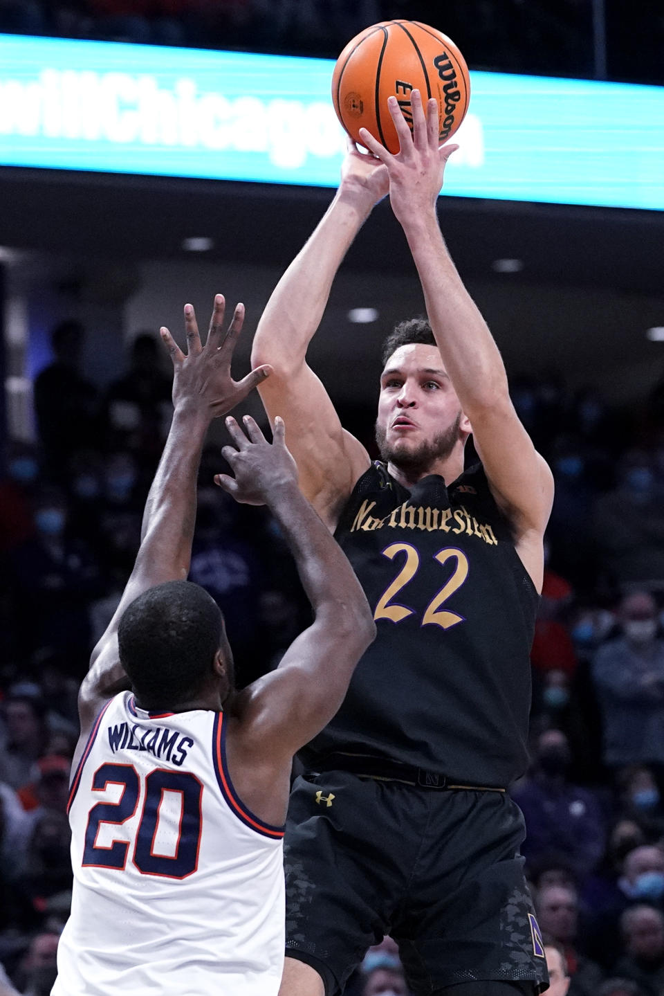 Northwestern forward Pete Nance, right, shoots against Illinois guard Da'Monte Williams during the second half of an NCAA college basketball game in Evanston, Ill., Saturday, Jan. 29, 2022. Illinois won 59-56. (AP Photo/Nam Y. Huh)