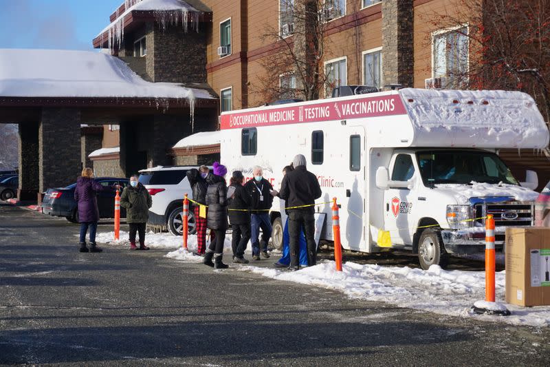 Support workers for the Iditarod Trail Sled Dog Race line up outside the Lakefront Anchorage Hotel, the site of the temporary Anchorage Iditarod headquarters, to be tested for coronavirus (COVID-19), in Anchorage, Alaska