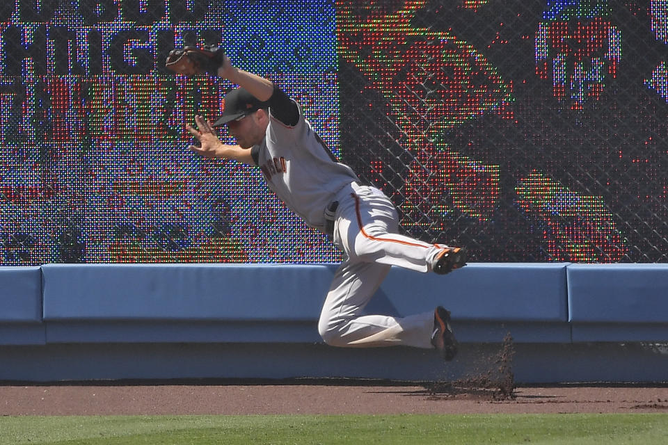 San Francisco Giants left fielder Austin Slater makes a catch on a ball hit by Los Angeles Dodgers' Corey Seager during the sixth inning of a baseball game Saturday, July 25, 2020, in Los Angeles. (AP Photo/Mark J. Terrill)