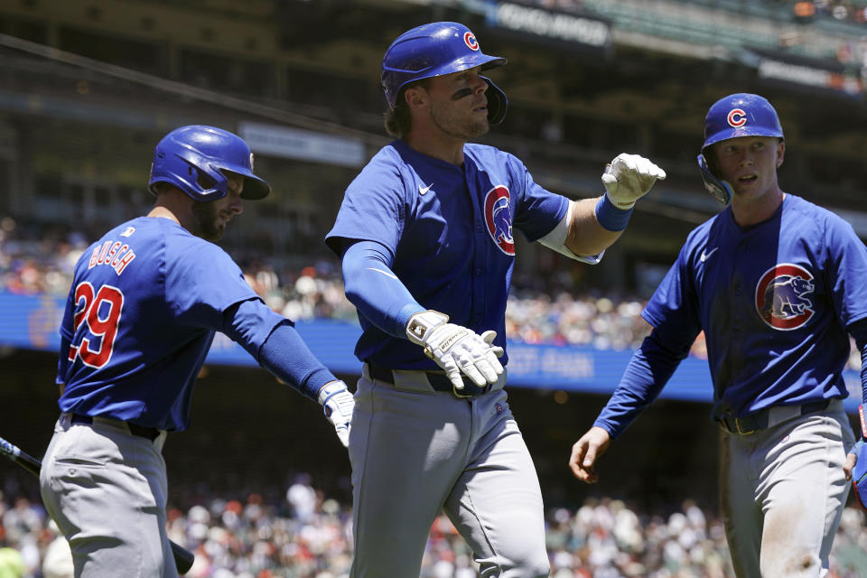 Chicago Cubs' Nico Hoerner (2) celebrates with Pete Crow-Armstrong (52) and Michael Busch (29) after hitting a two-run home run against the San Francisco Giants during the third inning of a baseball game Thursday, June 27, 2024, in San Francisco. (AP Photo/Kavin Mistry)