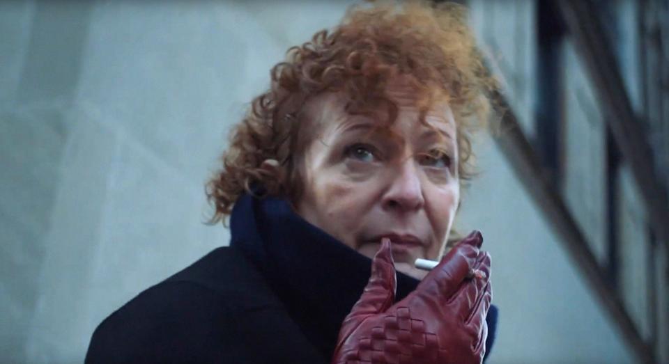 Nan Goldin smokes a cigarette