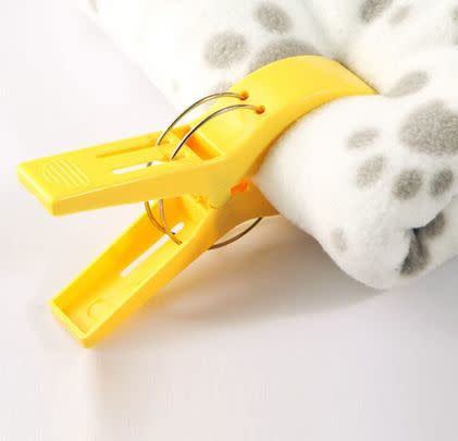 Use these big beach towel clips to hang bed sheets over the curtain rail