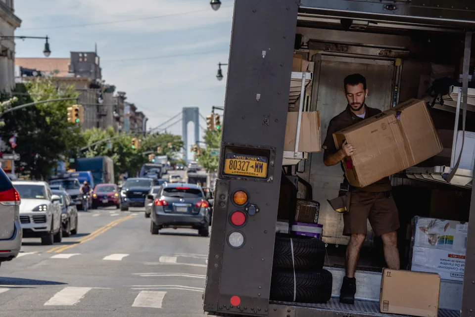 Matt Leichenger, a driver with UPS, delivers packages along his route in the Brooklyn neighborhood of New York on Tuesday, Aug. 16, 2022. (Johnny Milano/The New York Times)