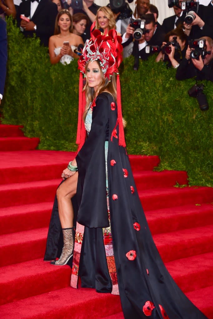 Parker walked the red carpet in a red and silver headpiece and a black dress. WireImage