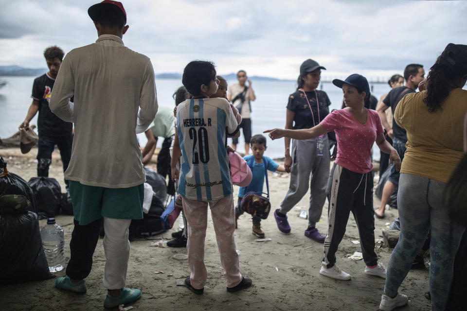 Migrants wait to be boarded in a boat, in Necocli, Colombia, Saturday, Oct. 7, 2023. New York City Mayor Eric Adams has capped off a four-day trip to Latin America with a visit to the northern Colombian city where thousands of migrants start the perilous trek across the Darien jungle, as they head to the United States. (AP Photo/Ivan Valencia)