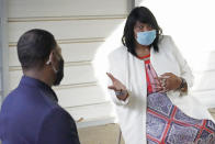 Doris Devine, Queens-Magnolia Terrace Subdivision President, addresses EPA Administrator Michael Regan, about how the city's water problems affects many neighborhoods, Monday, Nov. 15, 2021. Regan and others toured the school, as part of the agency's "Journey to Justice" tour through Mississippi, Louisiana and Texas, spotlighting longstanding environmental concerns in historically marginalized communities. (AP Photo/Rogelio V. Solis)