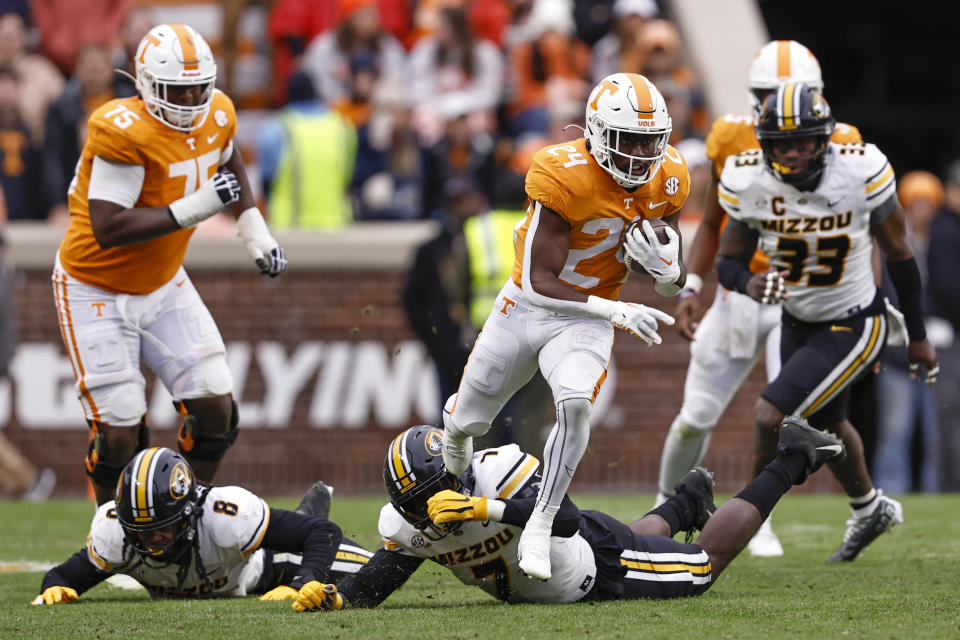 Tennessee running back Dylan Sampson (24) escapes from Missouri defensive lineman DJ Coleman (7) during the second half of an NCAA college football game Saturday, Nov. 12, 2022, in Knoxville, Tenn. (AP Photo/Wade Payne)