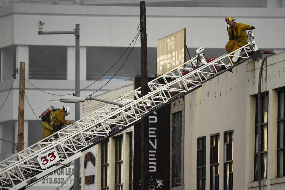 Los Angeles Fire Department firefighters work the scene of a structure fire that injured multiple firefighters, according to a fire department spokesman, Saturday, May 16, 2020, in Los Angeles. (AP Photo/Mark J. Terrill)