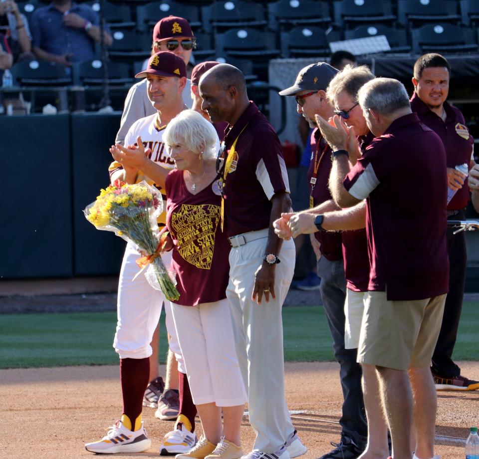 Arizona State baseball honored the 1981 College World Series before Saturday's game against Oregon, including Patsy Brock, center, the widow of head coach Jim Brock. Brock is seen with ASU head coach Willie Bloomquist, left, and ASU athletic director, Ray Anderson, right, at Phoenix Municipal Stadium on May 14, 2022.