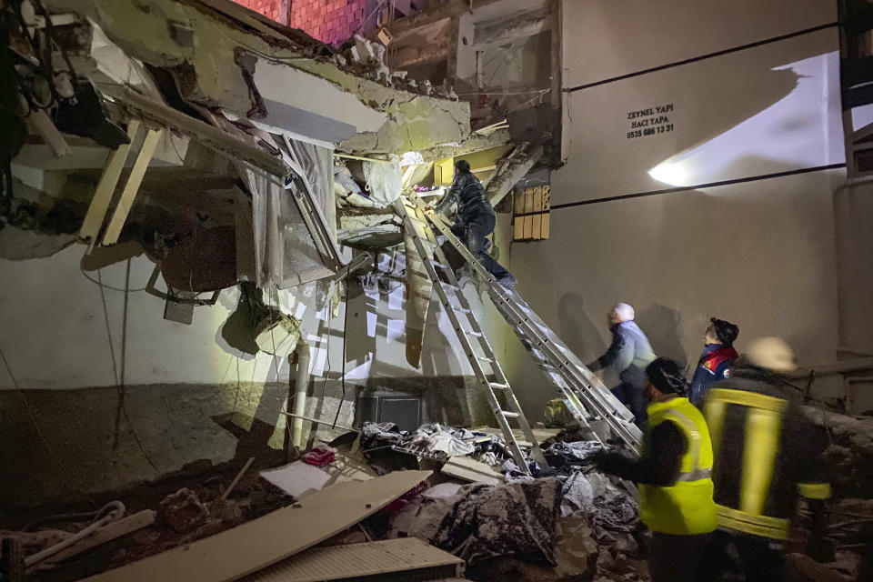 <p>Rescue teams try to reach trapped residents inside collapsed buildings in Adana, Turkey, Monday, Feb. 6, 2023. A powerful quake has knocked down multiple buildings in southeast Turkey and Syria and many casualties are feared. (IHA agency via AP)</p> 