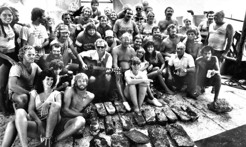 In this file photo from Key West in July 1985, Jimmy Buffett visits and seranades divers who were aboard a converted tugboat and searching through the remains of a sunken Spanish galleon, the Nuestra Senora de Atocha, that sank in a 1622 hurricane after it left Cuba laden with gold riches.