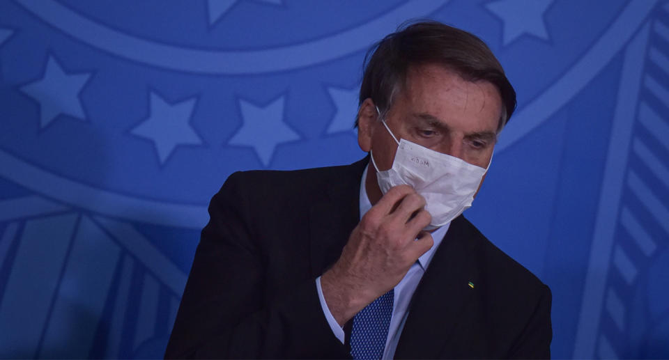 Photo of Brazilian President Jair Bolsonaro wearing a face mask after announcing he has COVID-19.