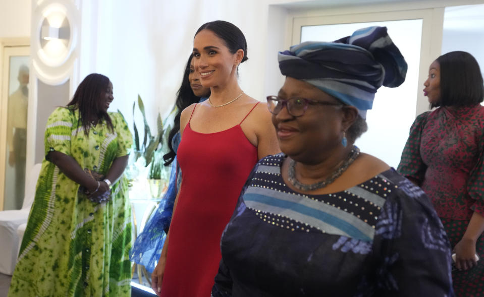 Meghan, the Duchess of Sussex, left, walks alongside Ngozi Okonjo-Iweala, right, Director-General of the World Trade Organization, during an event in Abuja, Nigeria, Saturday, May 11, 2024. Meghan, the Duchess of Sussex, says it’s been “humbling” to find out through a genealogy test that she is partly Nigerian. She was speaking at a meeting with Nigerian female industry leaders at an event on Saturday, her second day in the West African nation where she is visiting with Harry, her husband. (AP Photo/Sunday Alamba)