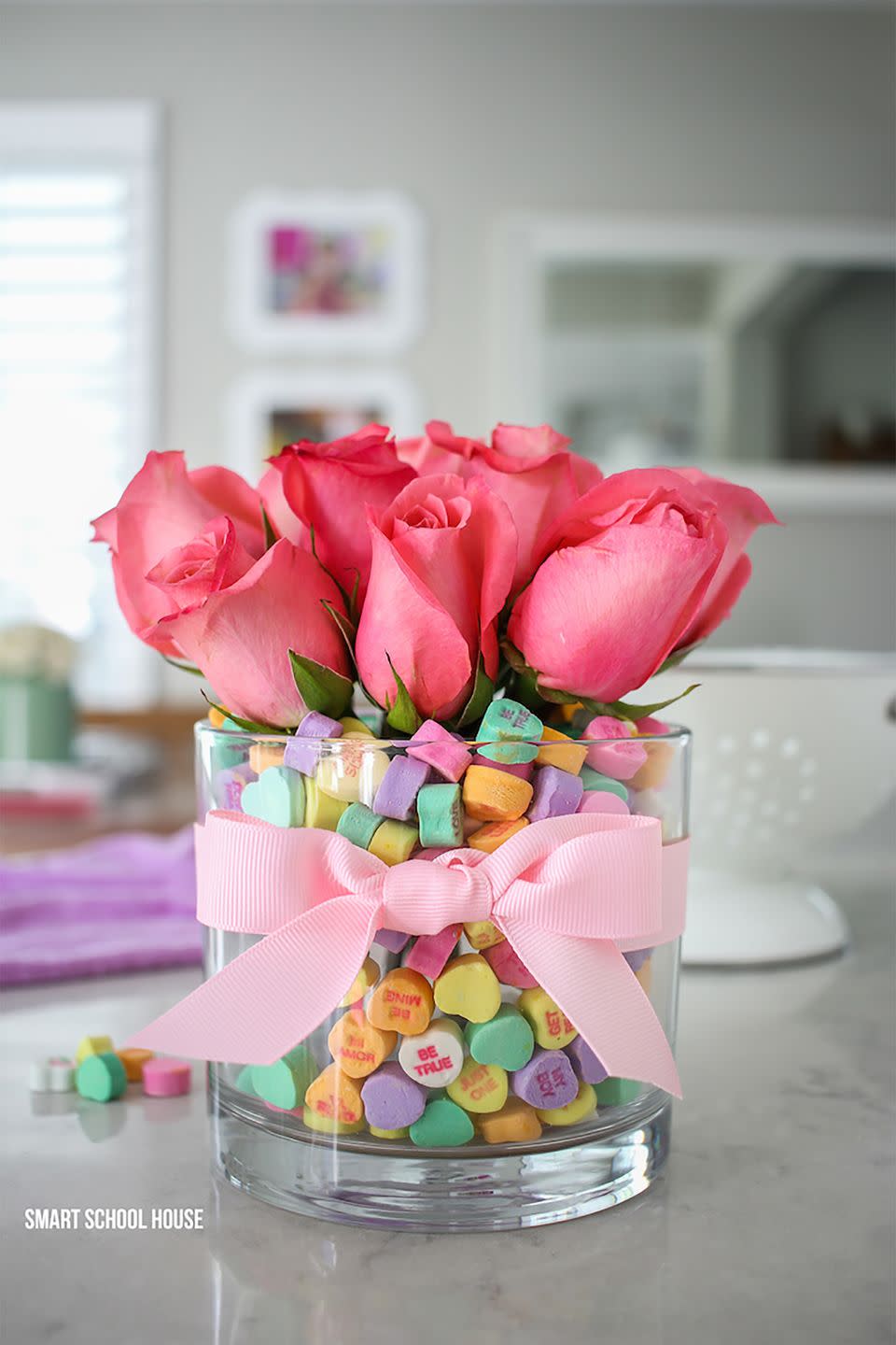 <p>A vase of water is actually hidden underneath a pile of conversational hearts.</p><p><strong>Get the tutorial at <a href="https://www.smartschoolhouse.com/diy-crafts/candy-heart-valentine-bouquet" rel="nofollow noopener" target="_blank" data-ylk="slk:Smart School House;elm:context_link;itc:0;sec:content-canvas" class="link ">Smart School House</a>.</strong></p><p><strong><a class="link " href="https://www.amazon.com/b?ie=UTF8&node=16091540011&tag=syn-yahoo-20&ascsubtag=%5Bartid%7C10050.g.2971%5Bsrc%7Cyahoo-us" rel="nofollow noopener" target="_blank" data-ylk="slk:SHOP GLASS VASES;elm:context_link;itc:0;sec:content-canvas">SHOP GLASS VASES</a><br></strong></p>