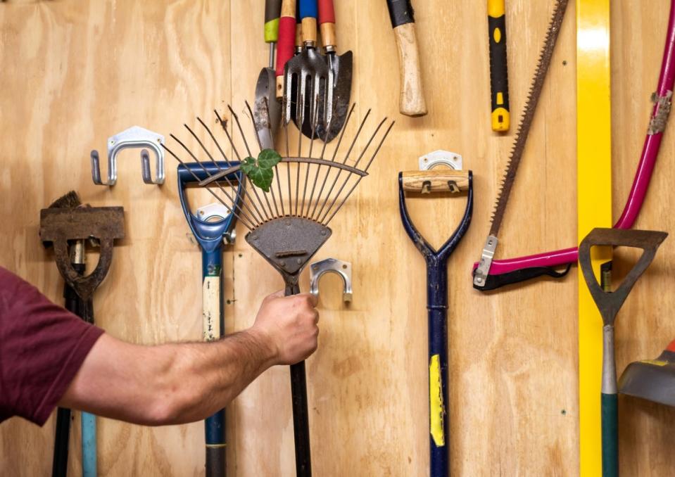 Person hanging rake.