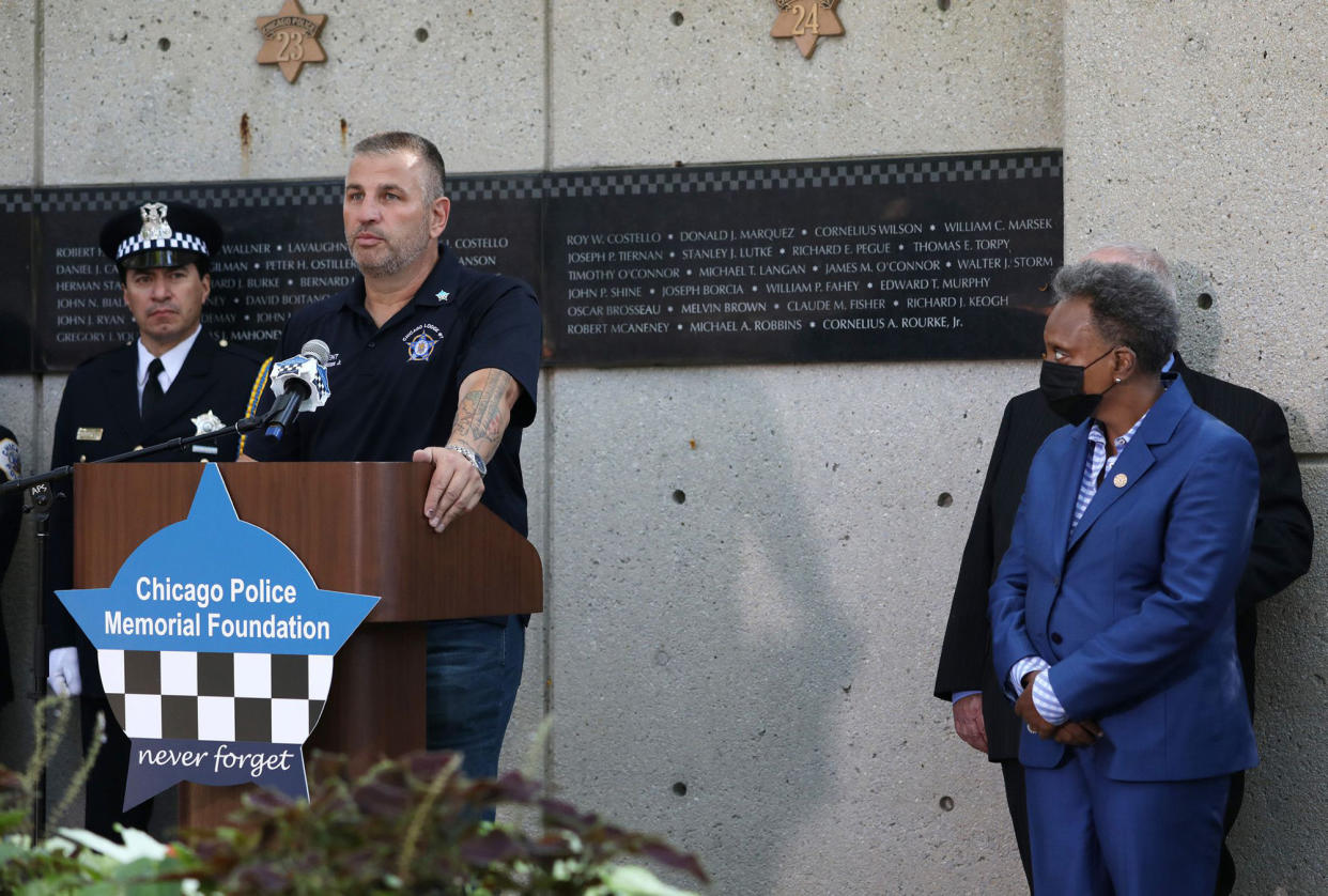 John Catanzara, president of the Chicago Fraternal Order of Police Lodge 7, addresses attendees as Mayor Lori Lightfoot watches during the unveiling of names for five Chicago police officers at the Gold Star Families Memorial and Park in September. (John J. Kim/Chicago Tribune/Tribune News Service via Getty Images)
