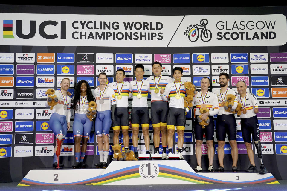 China's Zhangyu Li, Guoqing Wu and Shanzhang Lai, center, pose with their gold medals following the Mixed C Team Sprint, alongside Britain's Kadeena Cox, Jaco van Gass and Jody Cundy with silver, left, and Spain's Ricardo Ten Argiles, Pablo Jaramillo Gallardo and Alfonso Cabello Llamas with bronzeon day six of the 2023 UCI Cycling World Championships in Glasgow, Scotland, Tuesday, Aug. 8, 2023. (Tim Goode/PA via AP)
