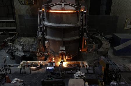 A worker controls the temperature of a casting roller at ThyssenKrupp Steel Europe AG in Duisburg November 29, 2013. REUTERS/Ina Fassbender