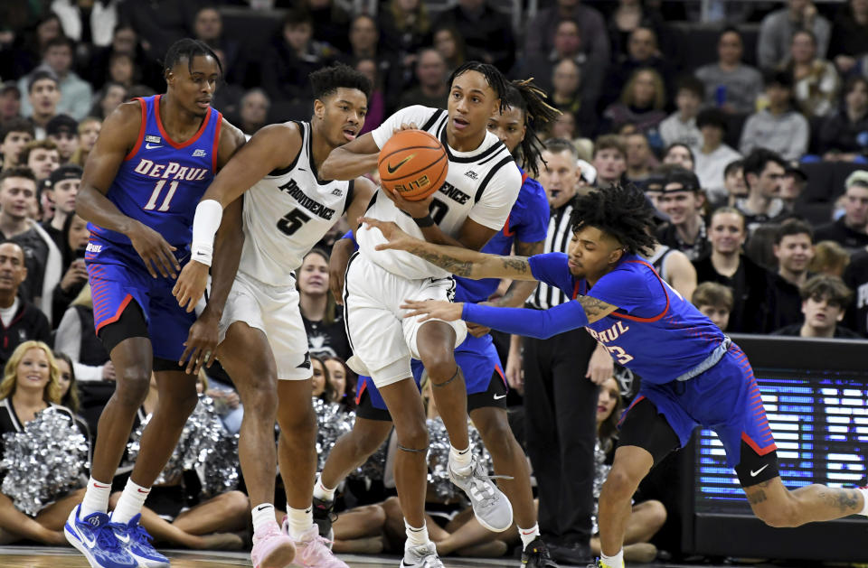 DePaul's Caleb Murphy (23) moves in to block a pass by Providence's Rafael Castro (30) during the first half of an NCAA college basketball game, Saturday, Jan. 21, 2023, in Providence, R.I. (AP Photo/Mark Stockwell)