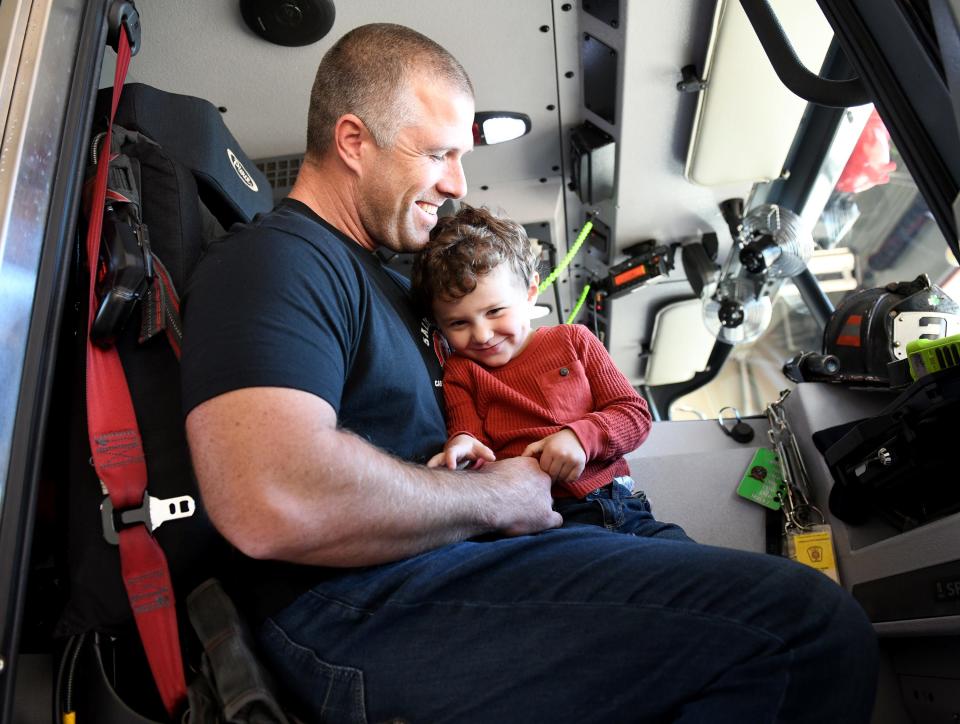 Brandon Records and his son Mason sit inside a fire truck Tuesday, Nov. 14, 2023, at the Salisbury Fire Department Station 2 in Salisbury, Maryland.