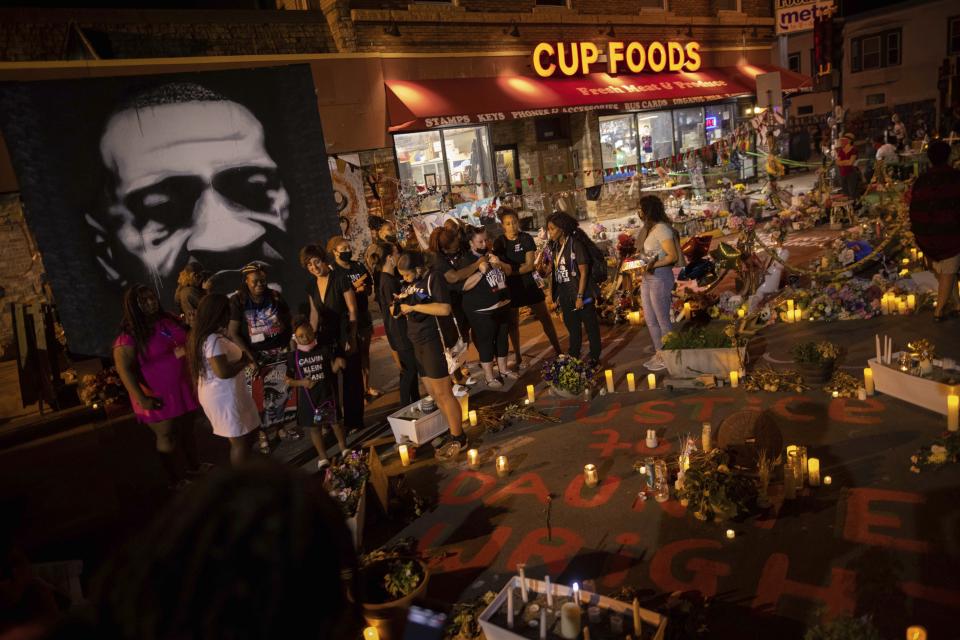 The family of Daunte Wright gathers on the one-year anniversary of George Floyd's death, Tuesday, May 25, 2021, in Minneapolis. Wright was fatally shot earlier this year by a Minneapolis police officer. (AP Photo/Christian Monterrosa)