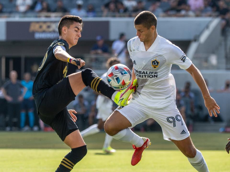 The Galaxy's Dejan Joveljic, right, battles LAFC's Eduard Atuesta on Aug. 28, 2021.