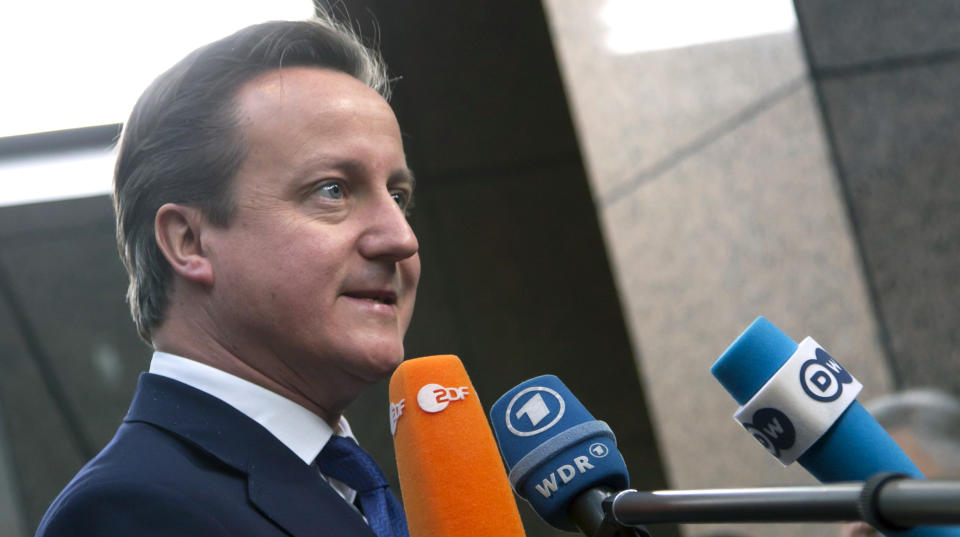 British Prime Minister David Cameron speaks with journalists as he arrives for an EU summit at the EU Council building in Brussels on Thursday, Nov. 22, 2012. EU leaders begin what is expected to be a marathon summit on the budget for the years 2014-2020. The meeting could last through Saturday and break up with no result and lots of finger-pointing. (AP Photo/Virginia Mayo)
