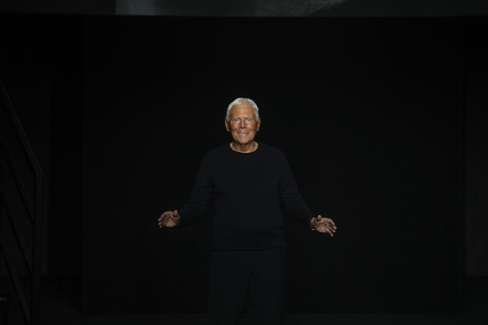 Designer Giorgio Armani accepts applause at the end of the Emporio Armani women's Fall-Winter 2023-24 collection presented in Milan, Italy, Thursday, Feb. 23, 2023. (AP Photo/Antonio Calanni)