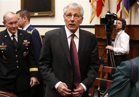 U.S. Secretary of Defense Chuck Hagel (C) and Chairman of the Joint Chiefs of Staff U.S. Army General Martin Dempsey (L) attend the House Armed Services Committee hearing on "The FY2015 National Defense Authorization Budget Request from the Department of Defense" on Capitol Hill in Washington March 6, 2014. REUTERS/Yuri Gripas