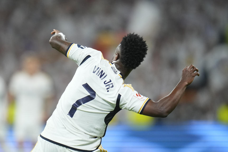 Real Madrid's Vinicius Junior celebrates after scoring his side's opening goal during the Spanish La Liga soccer match between Real Madrid and Barcelona at the Santiago Bernabeu stadium in Madrid, Spain, Sunday, April 21, 2024. (AP Photo/Manu Fernandez)