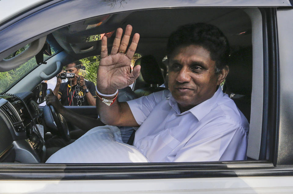 Presidential candidate of Sri Lanka's governing party Sajith Premadasa leaves a polling station after casting his vote in Weerawila, Sri Lanka, Saturday, Nov. 16 , 2019. A convoy of buses carrying Muslim voters traveling in northern Sri Lanka was attacked by gunfire and stones, and blocked by burning tires, around midnight on Saturday hours before polls opened in Sri Lanka’s presidential election, according to Colombo-based Centre for Monitoring Election Violence. Supporters of Premadasa had organized the convoy of Muslims who had fled their homes in the northern district of Mannar in 1982, when the insurgency of Tamil rebels demanding a separate country began to grow. (AP Photo/Chamila Karunarathne )