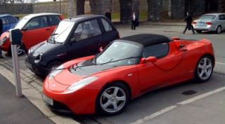Tesla Roadster, Reva i, & Ford Th!nk electric cars parked at charging station in Oslo, Norway
