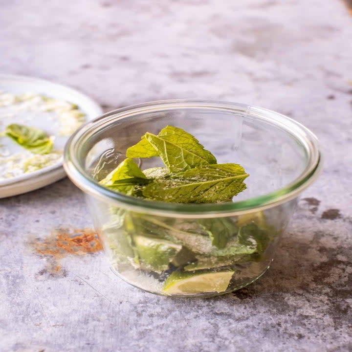 Mint and sugar in a glass.