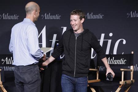 Facebook CEO Mark Zuckerberg (R) takes his seat for an onstage interview for with James Bennet (L) of the Atlantic Magazine in Washington, September 18, 2013. REUTERS/Jonathan Ernst