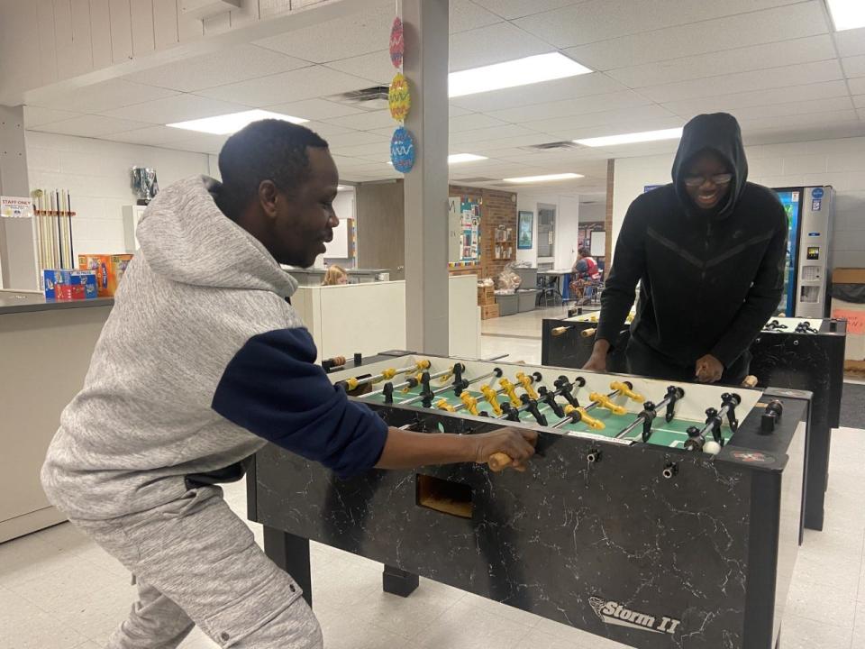 From left, Tresor Bengenge and Madry Kahulumbanda play foosball at the Coralville Recreation Center, April 1.